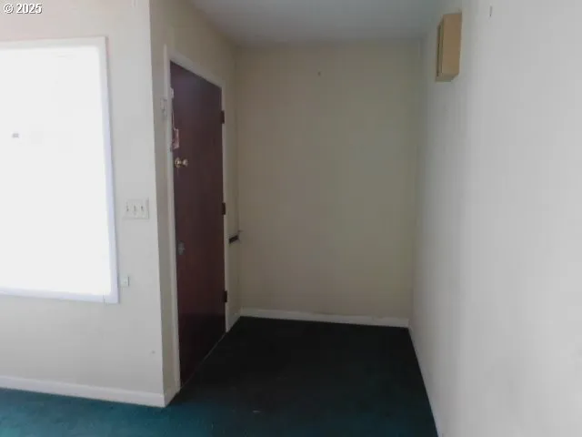 a small space with wooden floor and a window