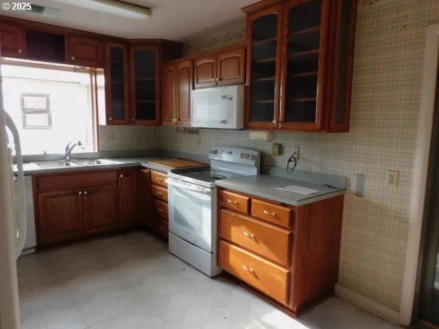 a kitchen with stainless steel appliances granite countertop a sink stove and cabinets