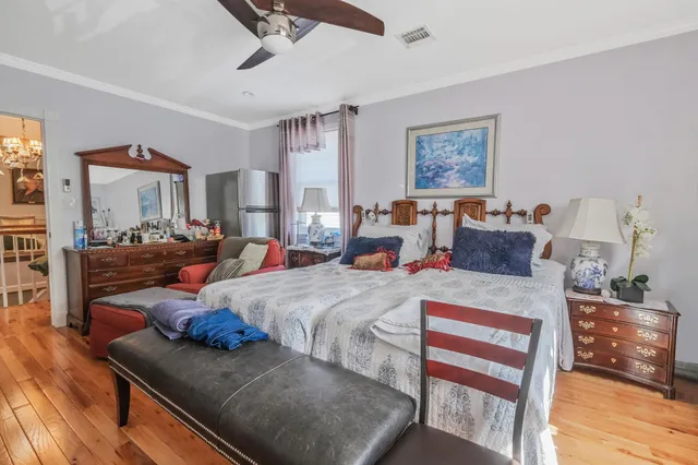 a bed room with a bed and wooden floor