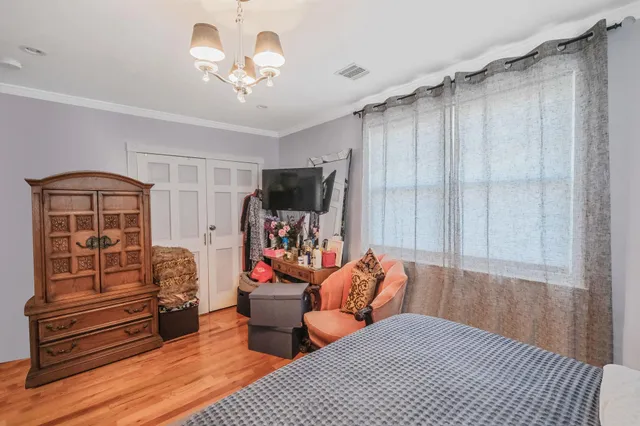 a bedroom with furniture and a chandelier