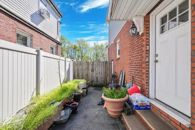 a view of a backyard with potted plants