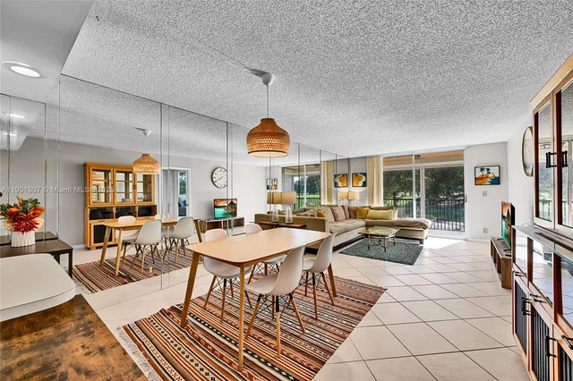 a living room with patio furniture and a large window