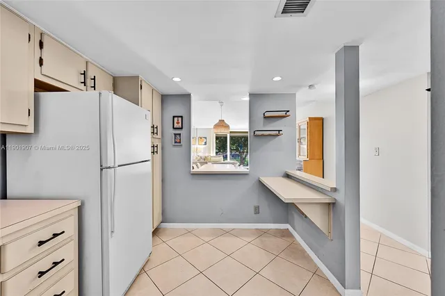 a kitchen with a refrigerator and countertop