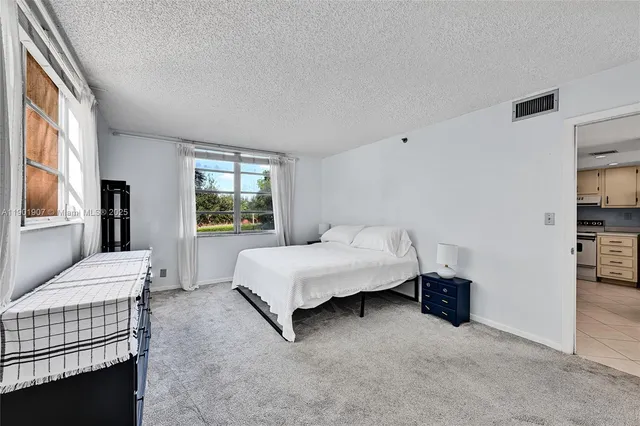 a spacious bedroom with a bed and a window