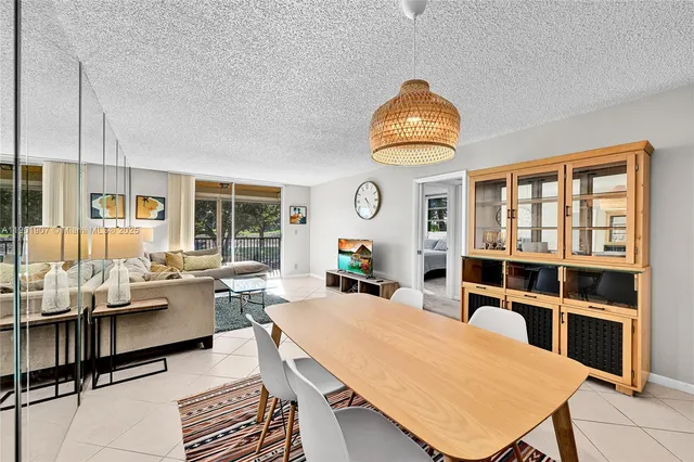 a living room with furniture a rug and a chandelier
