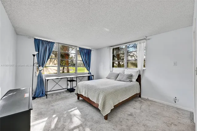 a bedroom with 2 bed and a table