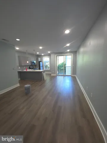 a view of a room with wooden floor