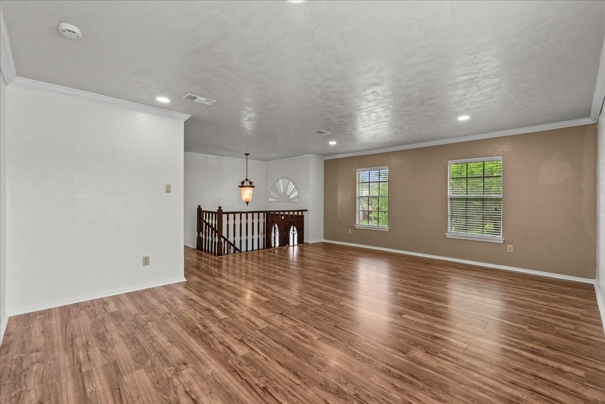 430 Redway Lane Houston, TX 77598 - Photo 17 of 43 an empty room with wooden floor and windows