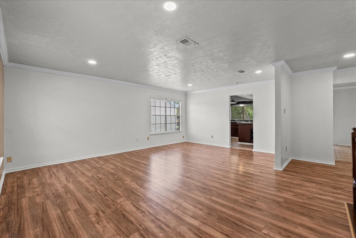 430 Redway Lane Houston, TX 77598 - Photo 18 of 43 a view of an empty room with wooden floor and a window