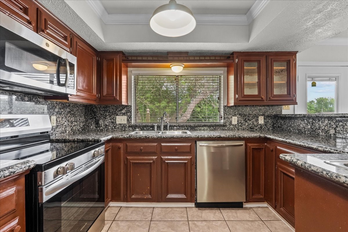 430 Redway Lane Houston, TX 77598 - Photo 21 of 43 a kitchen with stainless steel appliances granite countertop a stove sink and cabinets