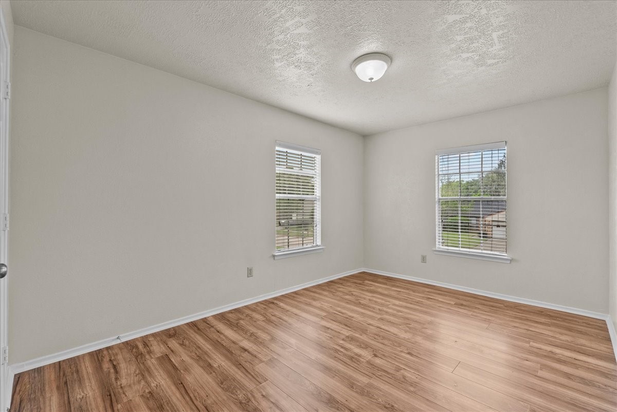 430 Redway Lane Houston, TX 77598 - Photo 25 of 43 a view of an empty room with wooden floor and a window