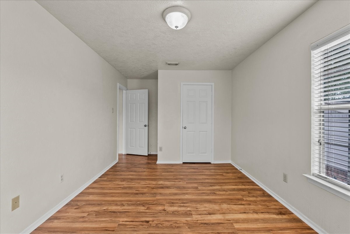 430 Redway Lane Houston, TX 77598 - Photo 27 of 43 a view of a room with wooden floor and a ceiling fan