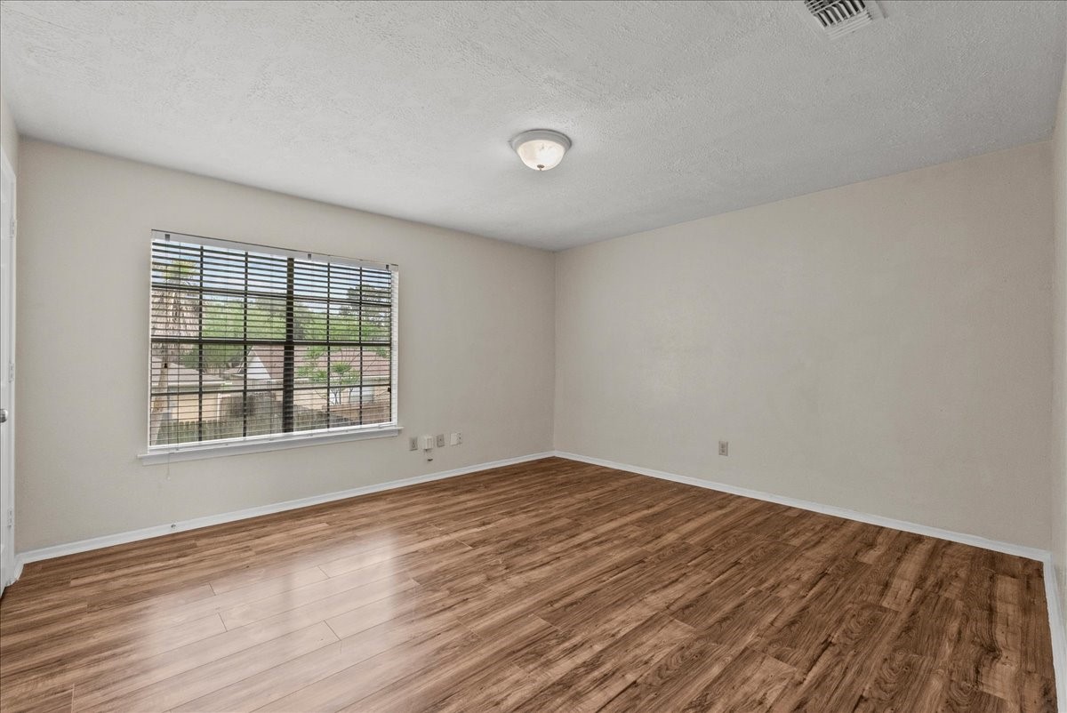 430 Redway Lane Houston, TX 77598 - Photo 28 of 43 an empty room with wooden floor and windows