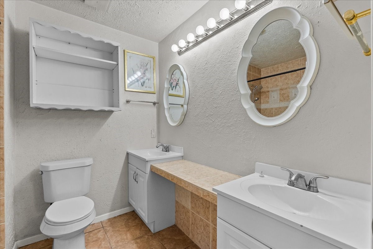 430 Redway Lane Houston, TX 77598 - Photo 30 of 43 a bathroom with a toilet a sink and a mirror