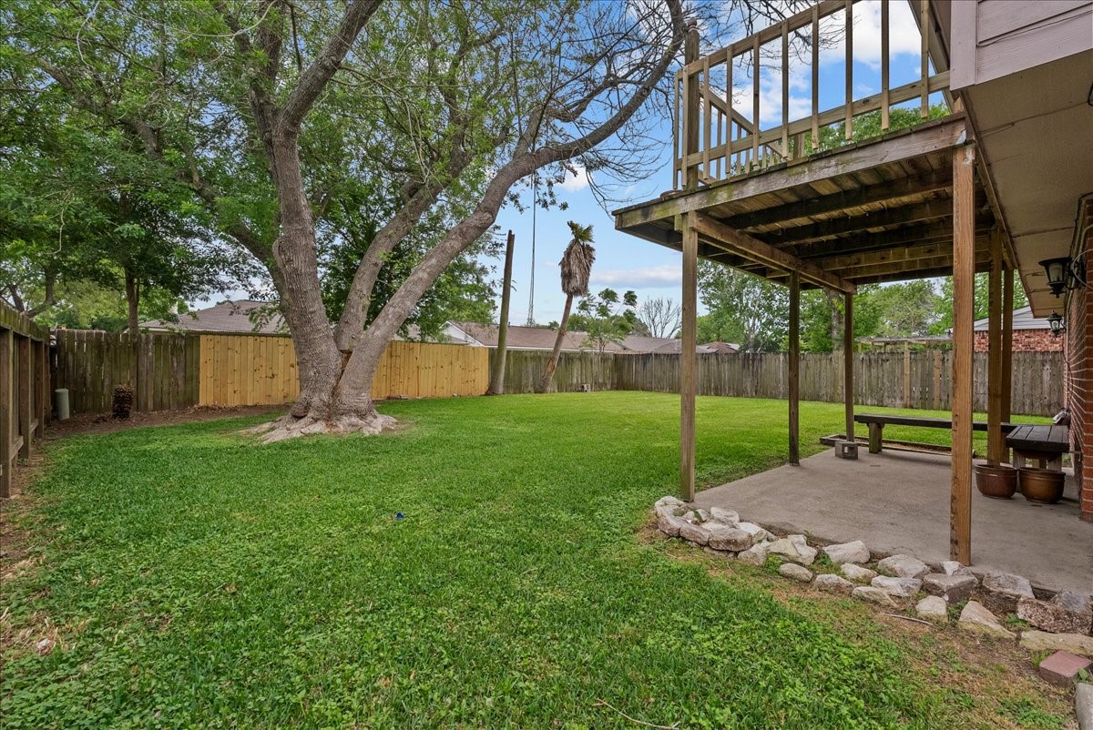 430 Redway Lane Houston, TX 77598 - Photo 34 of 43 a view of a backyard with table and chairs under a large tree