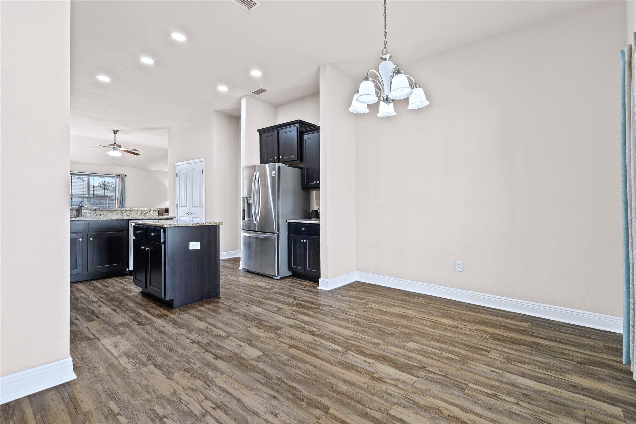 14607 Silvermere Drive Foley, AL 36535 - Photo 6 of 31 Kitchen featuring a center island, recessed lighting, dark wood-style floors, decorative light fixtures, and stainless steel refrigerator with ice dispenser
