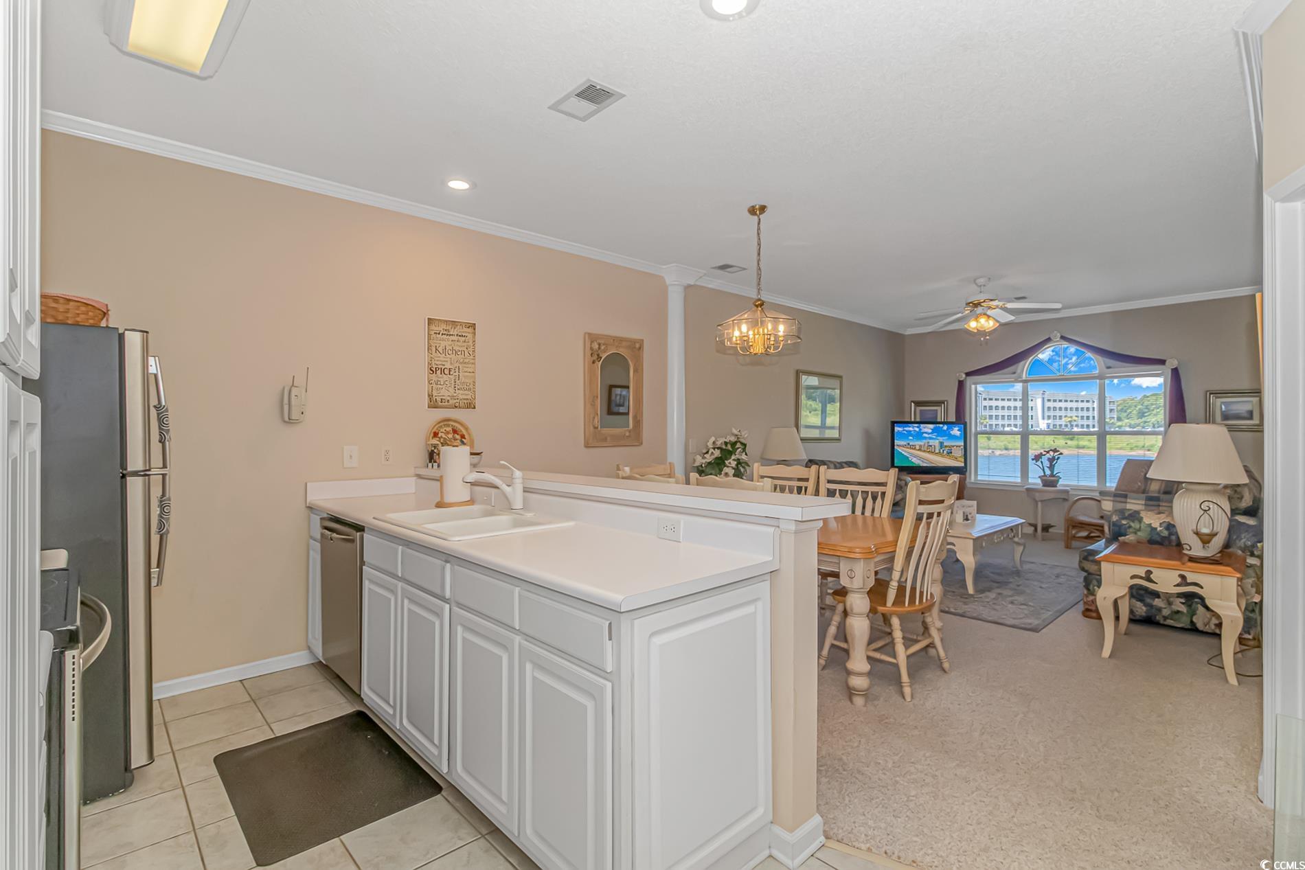 4501 West Harbour Court, Unit R6 Little River, SC 29566 - Photo 4 of 25 Kitchen with light tile flooring, ceiling fan with