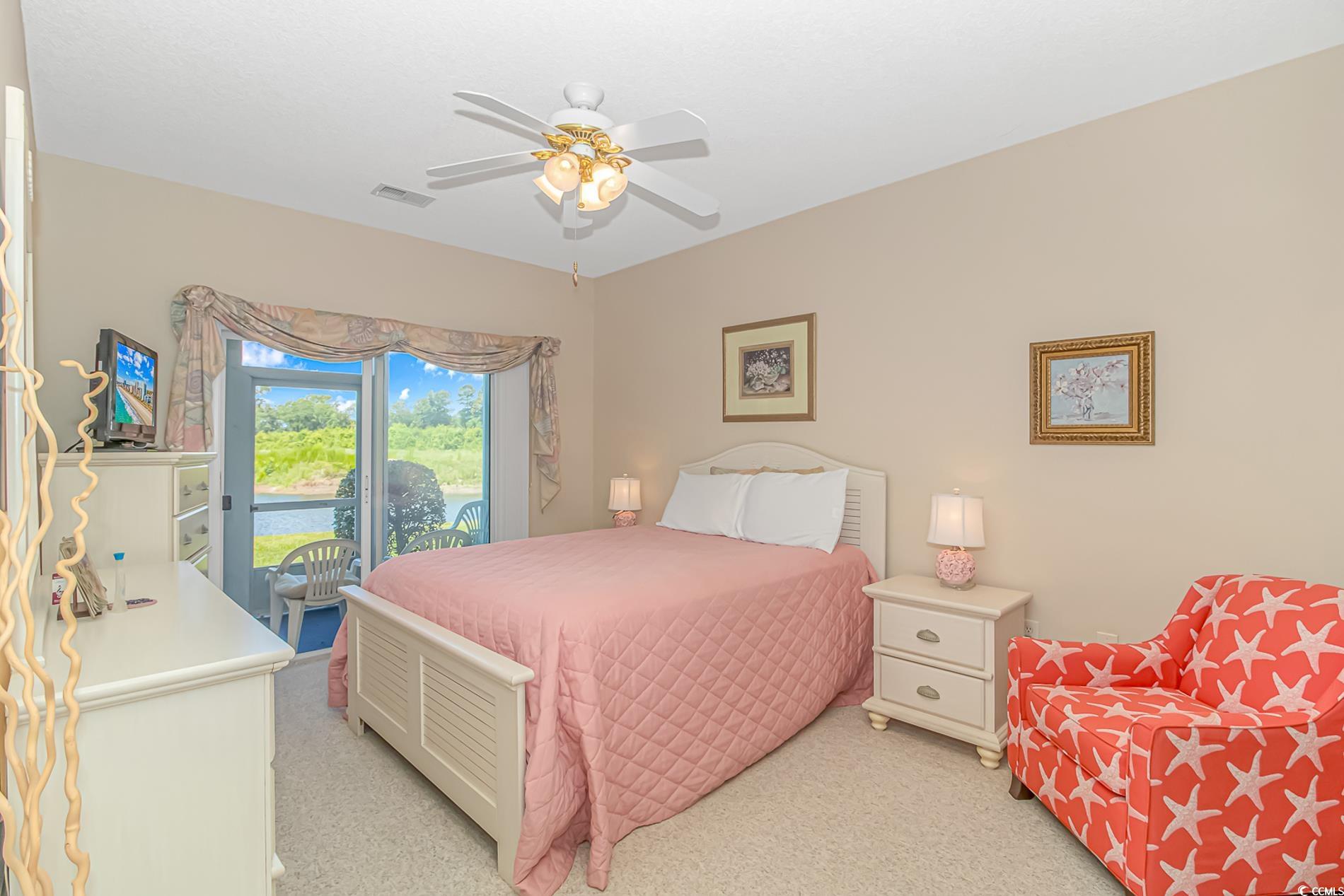 4501 West Harbour Court, Unit R6 Little River, SC 29566 - Photo 8 of 25 Bedroom featuring light carpet, ceiling fan, and a
