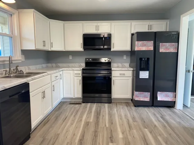 a kitchen with stainless steel appliances granite countertop a stove and a refrigerator