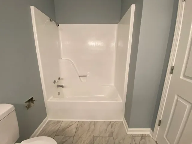 a bathroom with a shower and a toilet