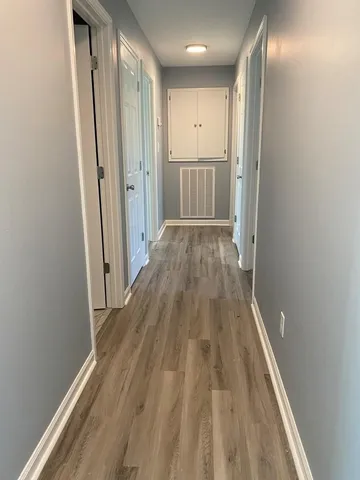 a view of hallway with wooden floor