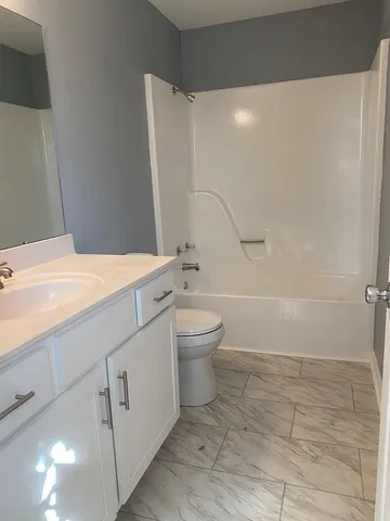 a bathroom with a sink a toilet and a shower