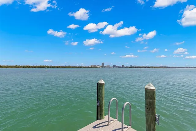 a living room with furniture fireplace and a large window