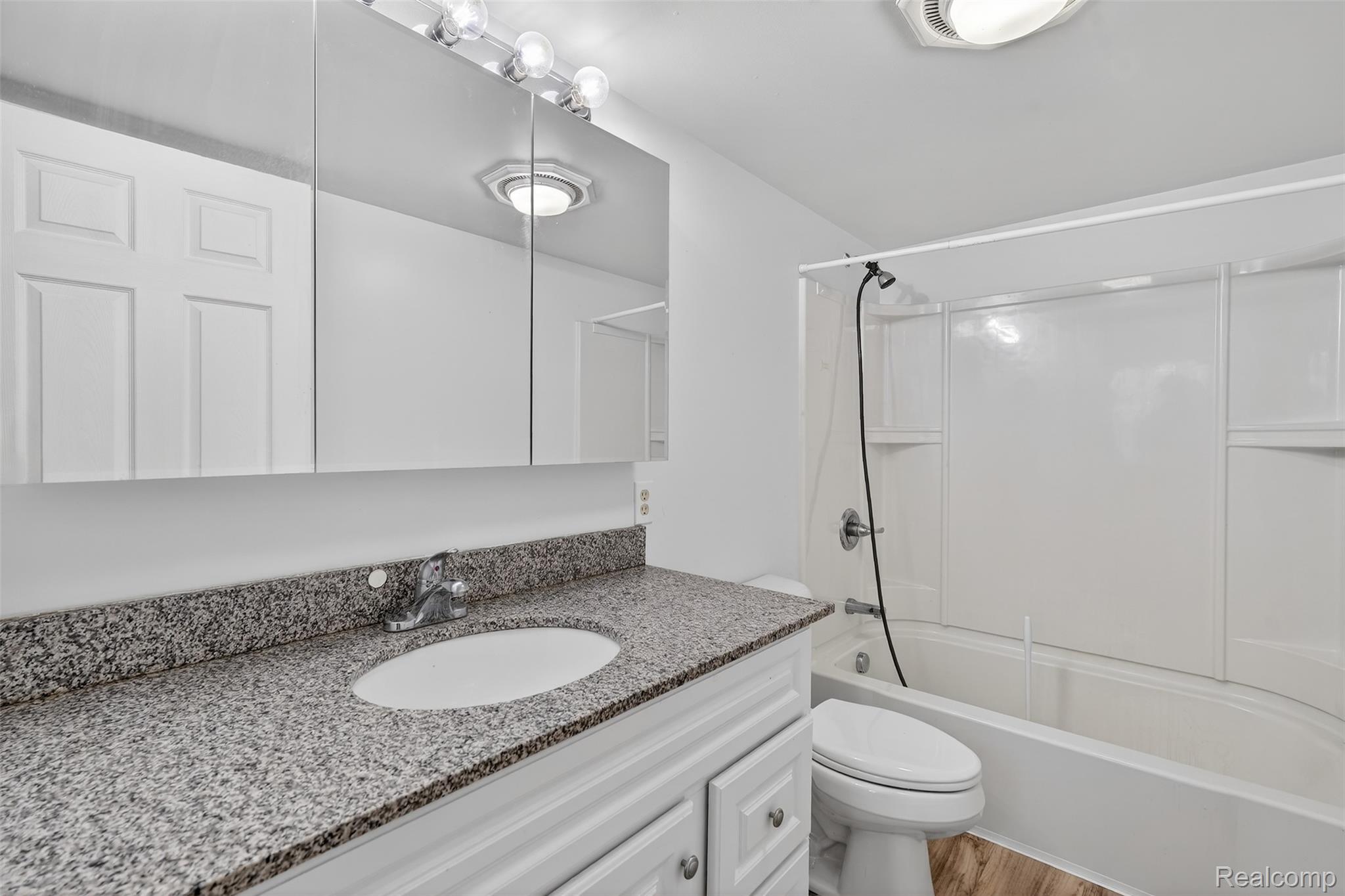 5417 Rensselear Drive Lapeer, MI 48446 - Photo 32 of 41 Bathroom featuring shower / bathtub combination, vanity, and light wood-style floors