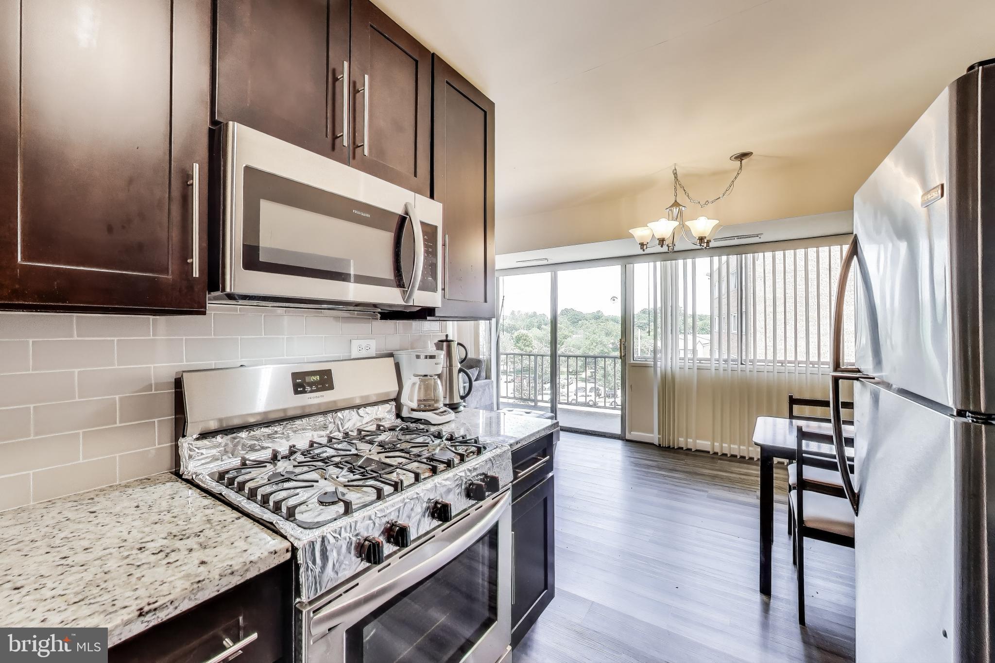 a kitchen with a stove a sink and a microwave