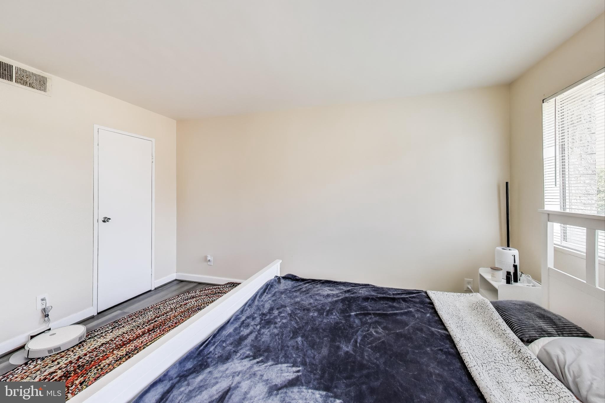 5851 Quantrell Avenue, Unit 407 Alexandria, VA 22312 - Photo 13 of 27 a bedroom with a bed and a window