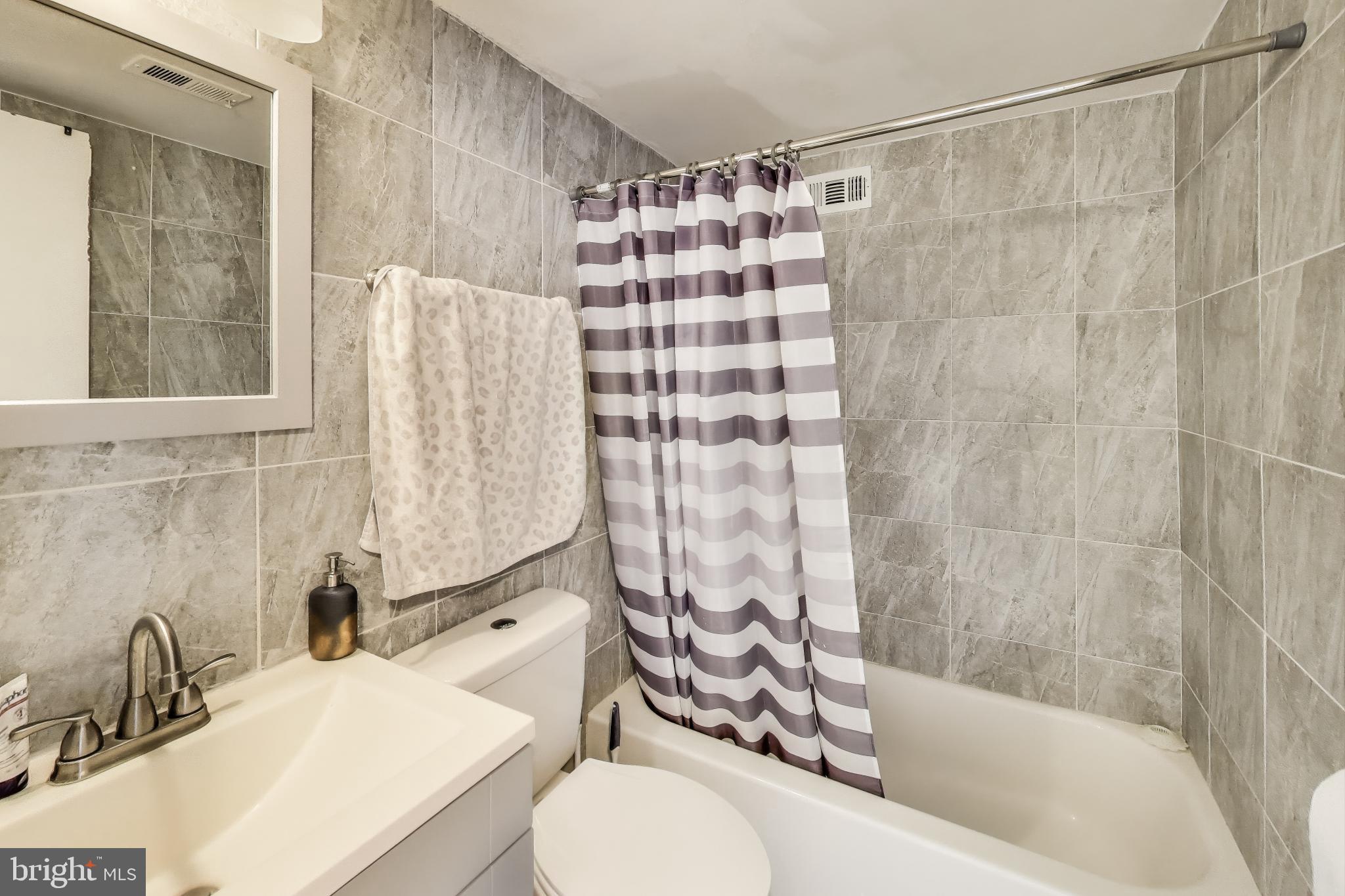 5851 Quantrell Avenue, Unit 407 Alexandria, VA 22312 - Photo 14 of 27 a bathroom with a sink toilet and shower