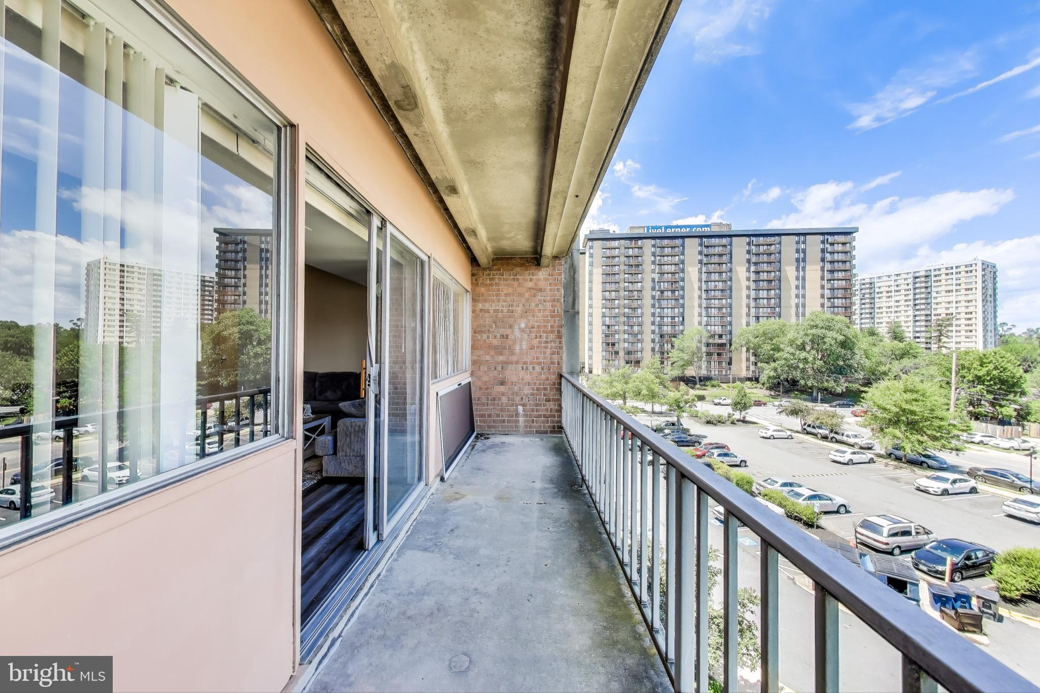 5851 Quantrell Avenue, Unit 407 Alexandria, VA 22312 - Photo 16 of 27 a view of balcony with wooden floor and seating space
