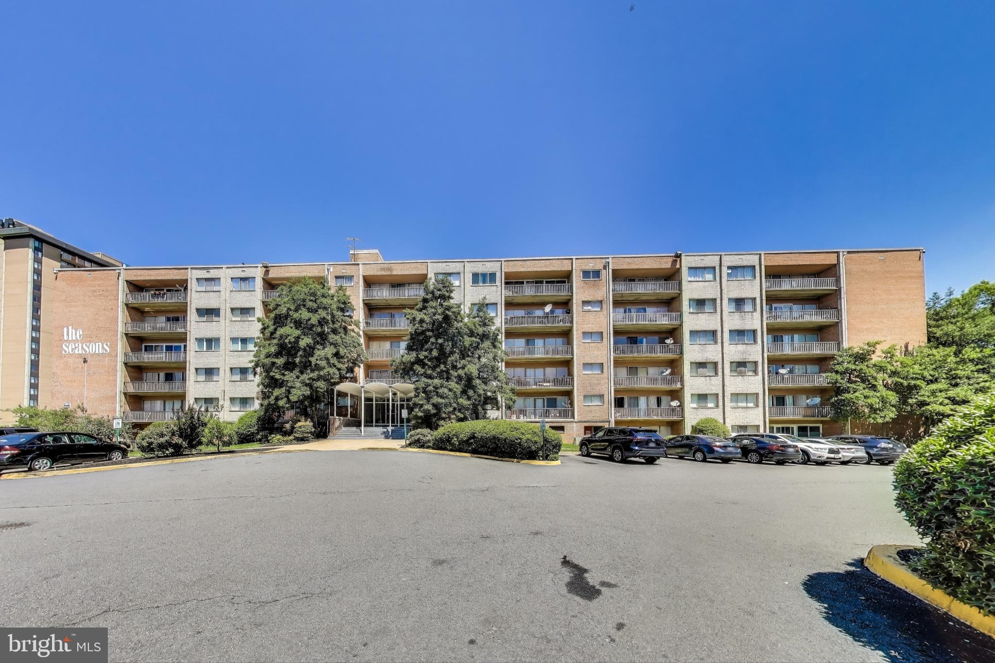 5851 Quantrell Avenue, Unit 407 Alexandria, VA 22312 - Photo 18 of 27 a tall building with a yard