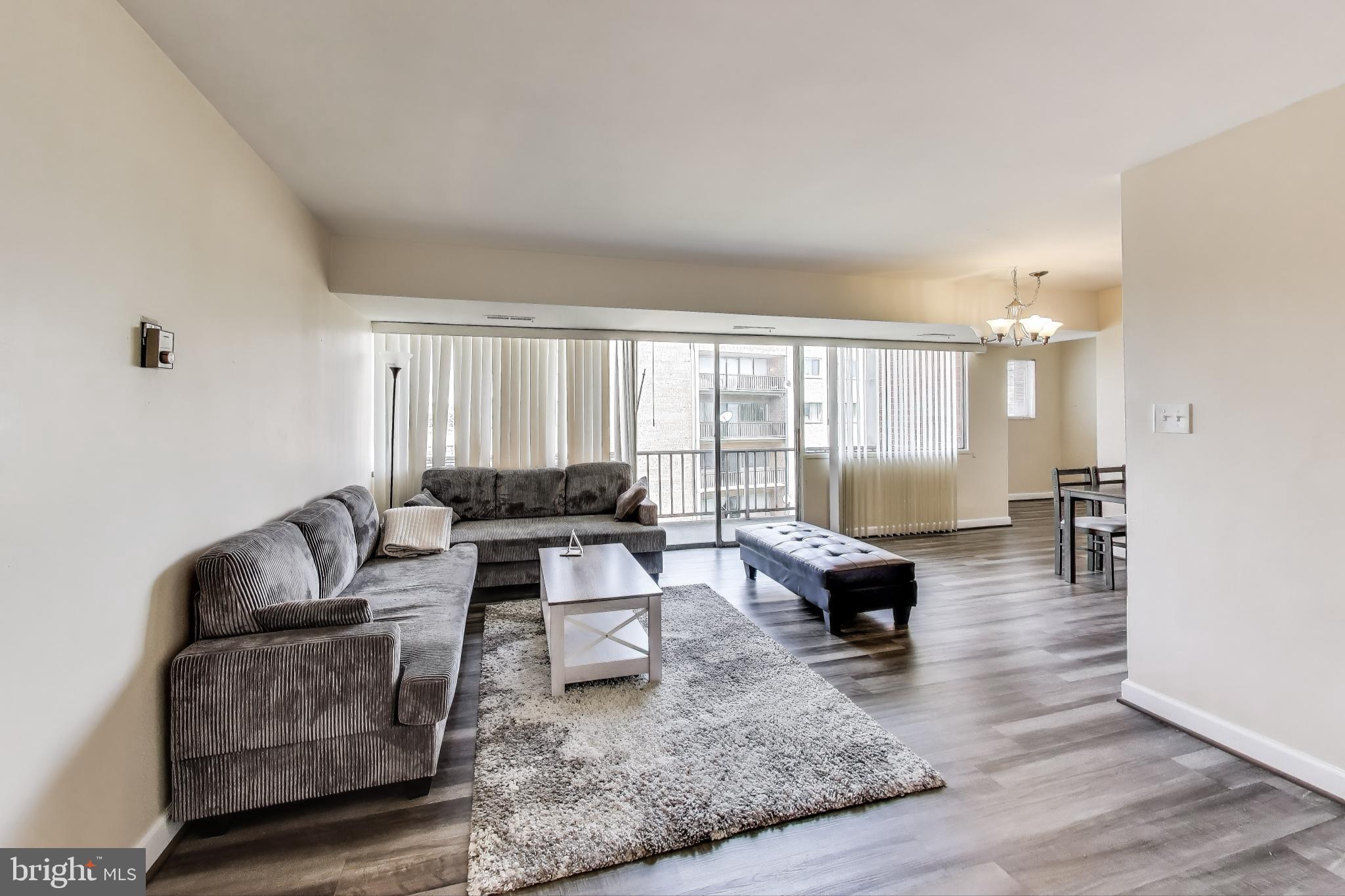 5851 Quantrell Avenue, Unit 407 Alexandria, VA 22312 - Photo 2 of 27 a living room with furniture and a large window