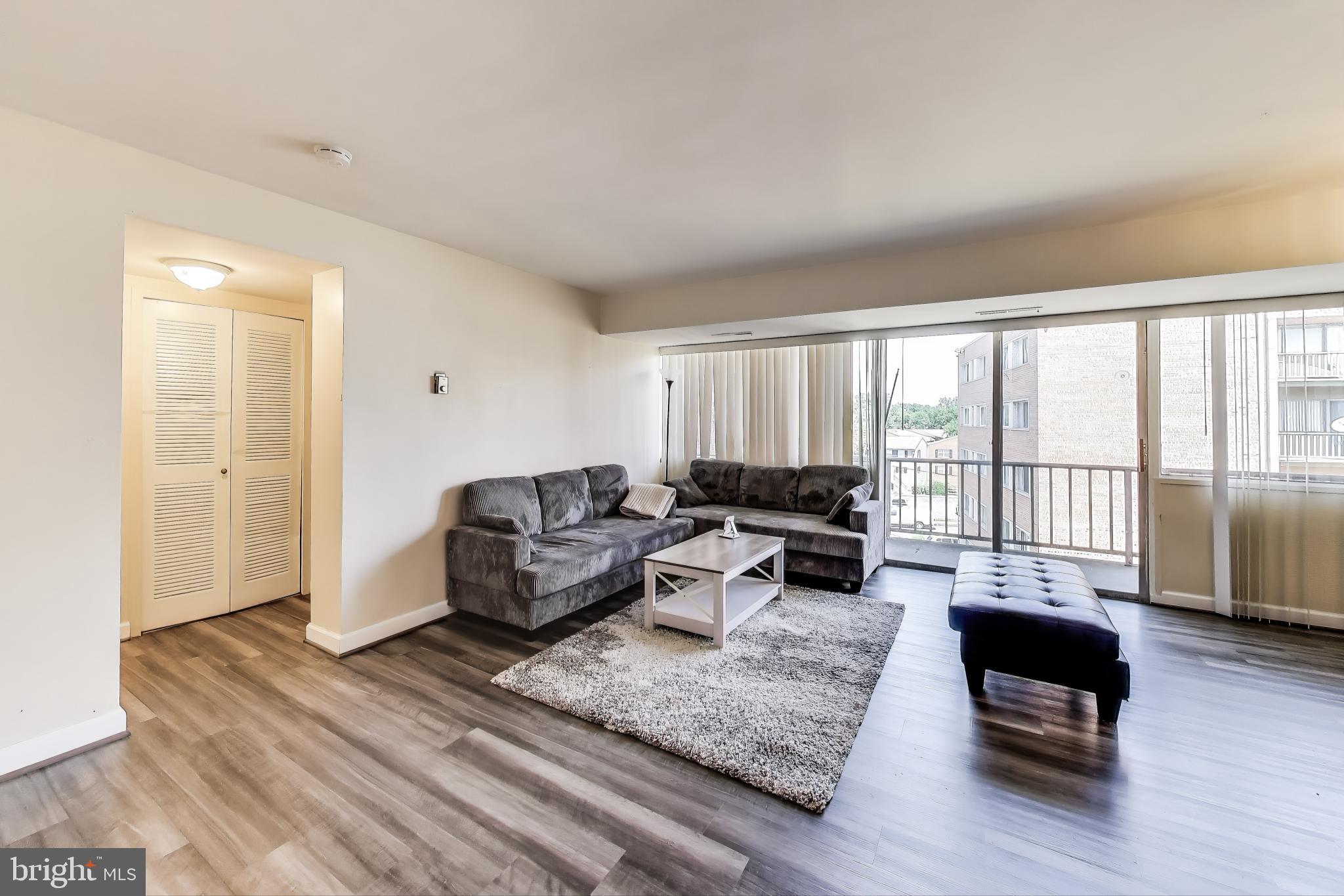 5851 Quantrell Avenue, Unit 407 Alexandria, VA 22312 - Photo 3 of 27 a living room with furniture and a large window