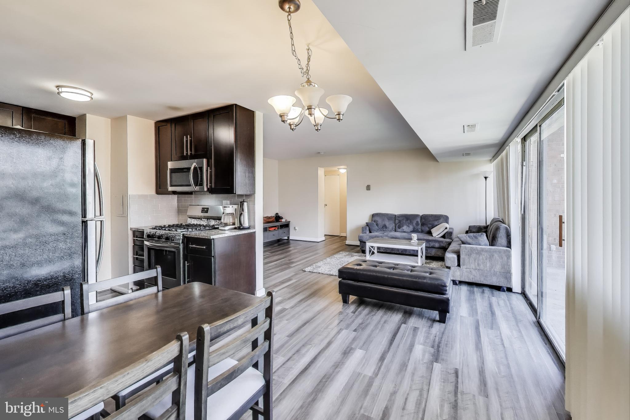 5851 Quantrell Avenue, Unit 407 Alexandria, VA 22312 - Photo 5 of 27 a living room with furniture and a flat screen tv