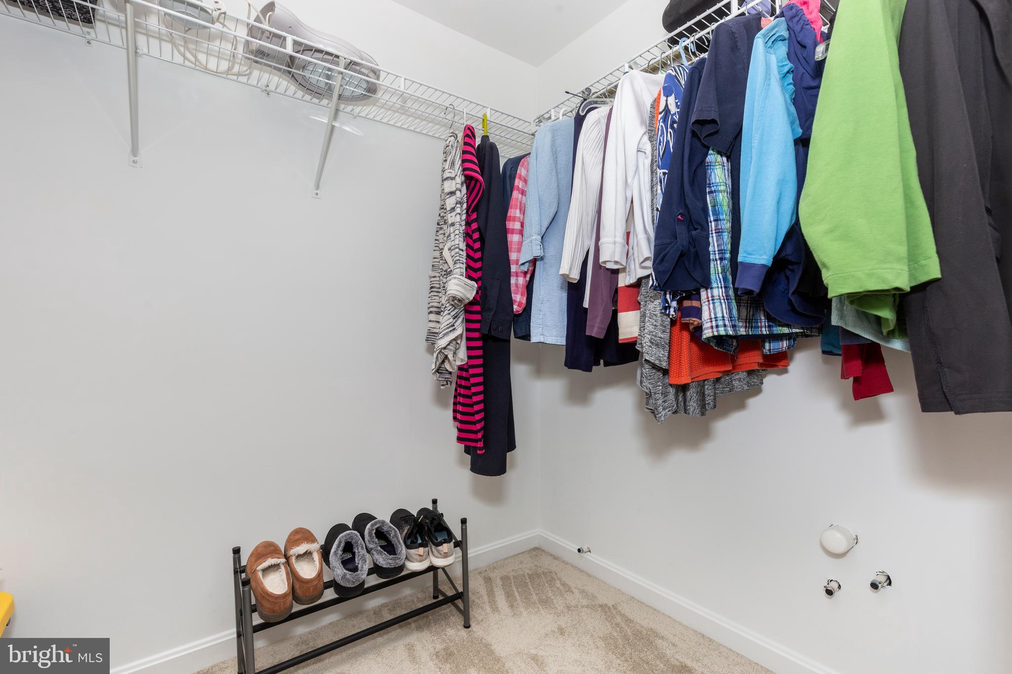 3850 Normandy Drive, Unit 2B Hampstead, MD 21074 - Photo 16 of 26 a view of walk in closet with clothes and shoes