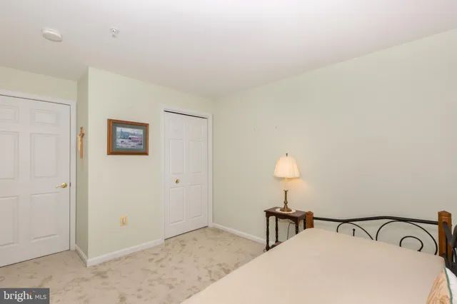 a bedroom with a bed and a lamp