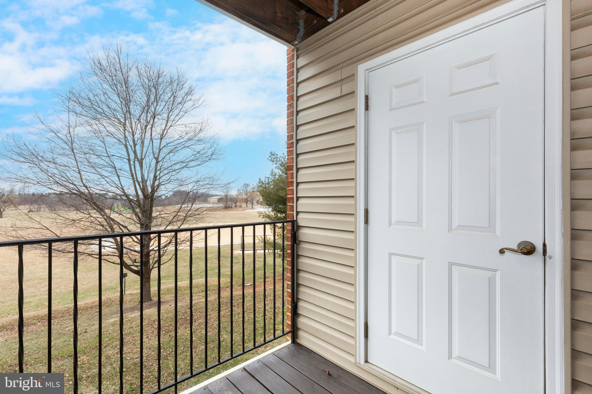 3850 Normandy Drive, Unit 2B Hampstead, MD 21074 - Photo 23 of 26 a view of a balcony with wooden floor