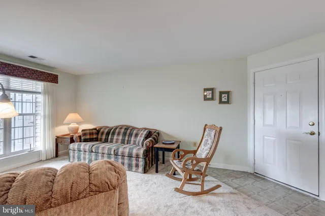a bedroom with a bed chair and window