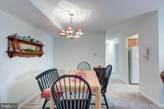 a view of a dining room with furniture and chandelier