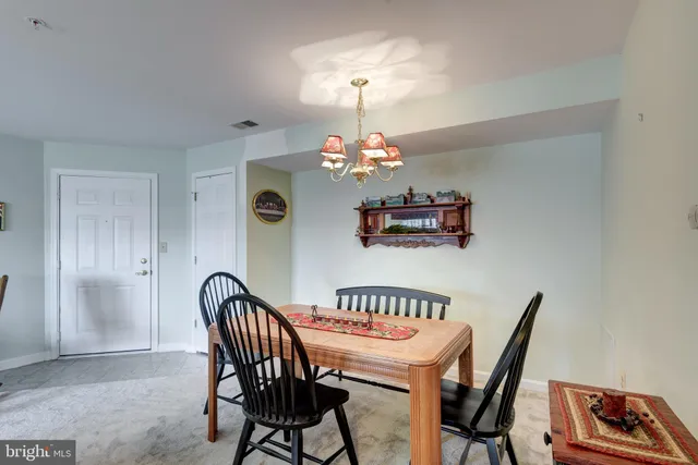 a view of a dining room with furniture and chandelier