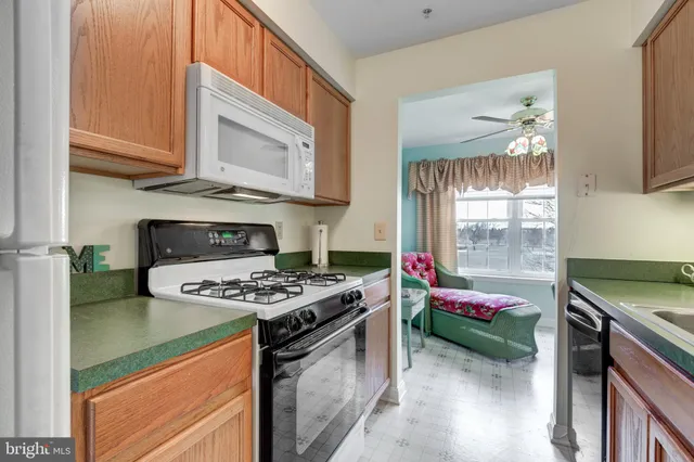 a kitchen with kitchen island stainless steel appliances a stove a sink and a microwave