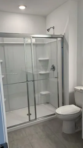 a bathroom with a shower and a toilet