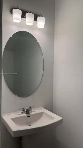 a bathroom with a sink and mirror