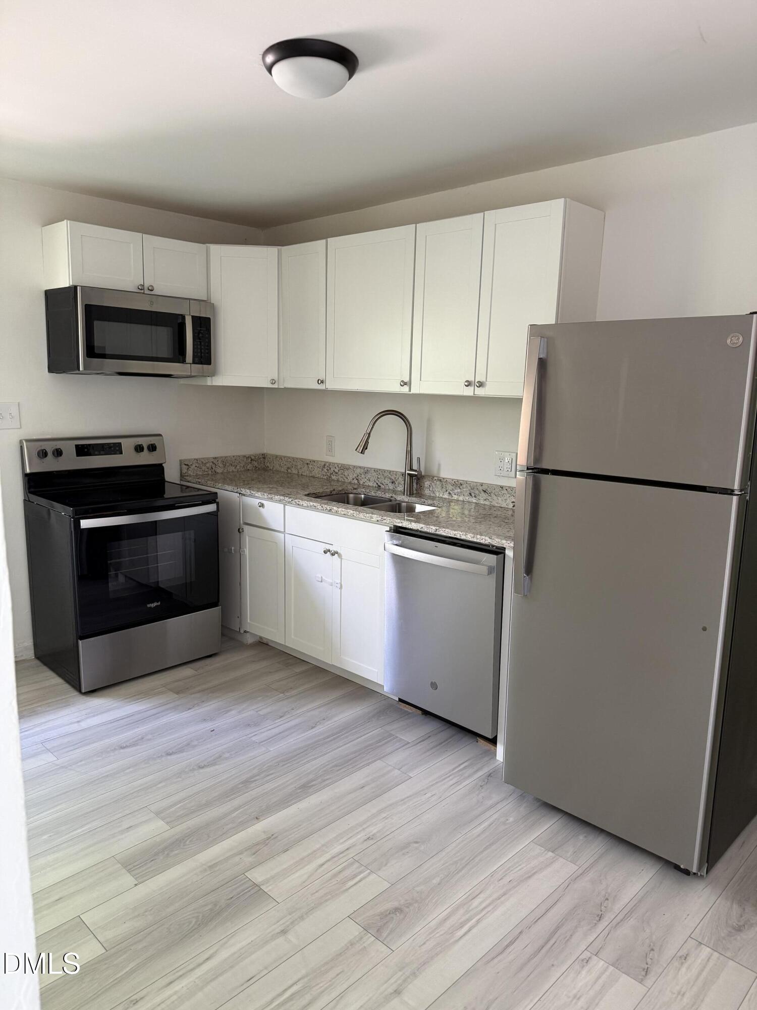 1015 Rosedale Avenue Durham, NC 27707 - Photo 4 of 15 a kitchen with stainless steel appliances granite countertop a refrigerator stove a sink and a microwave