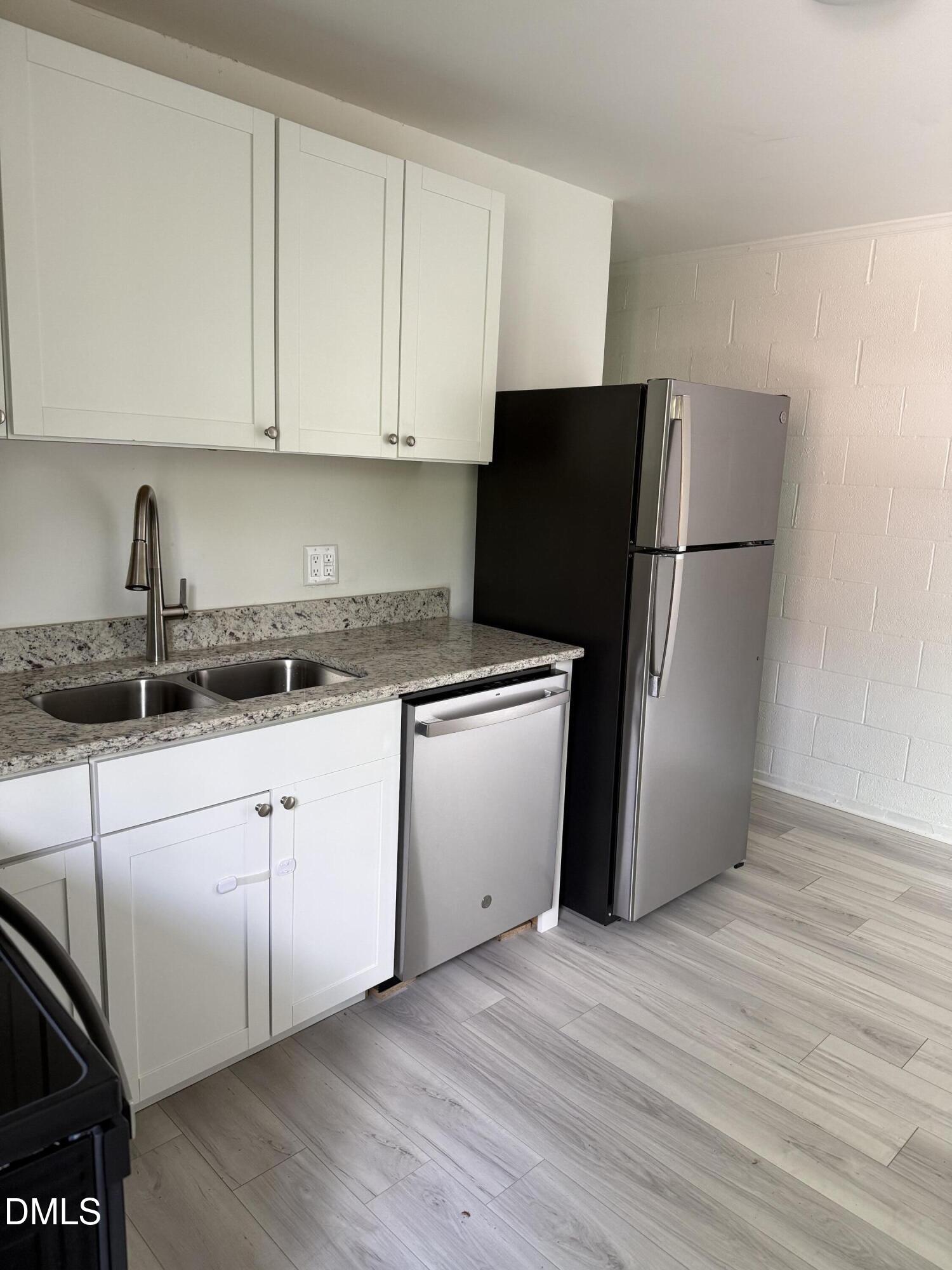 1015 Rosedale Avenue Durham, NC 27707 - Photo 6 of 15 a kitchen with a refrigerator and cabinets
