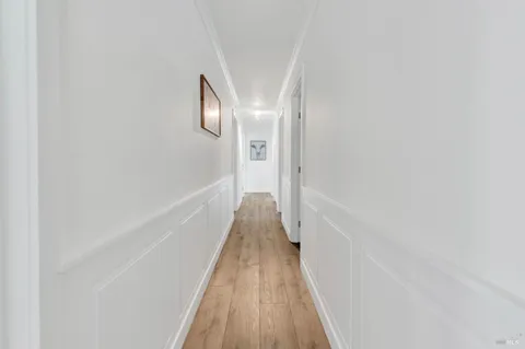 an empty room with wooden floor and window