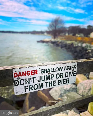 a street sign on a wall next to a road