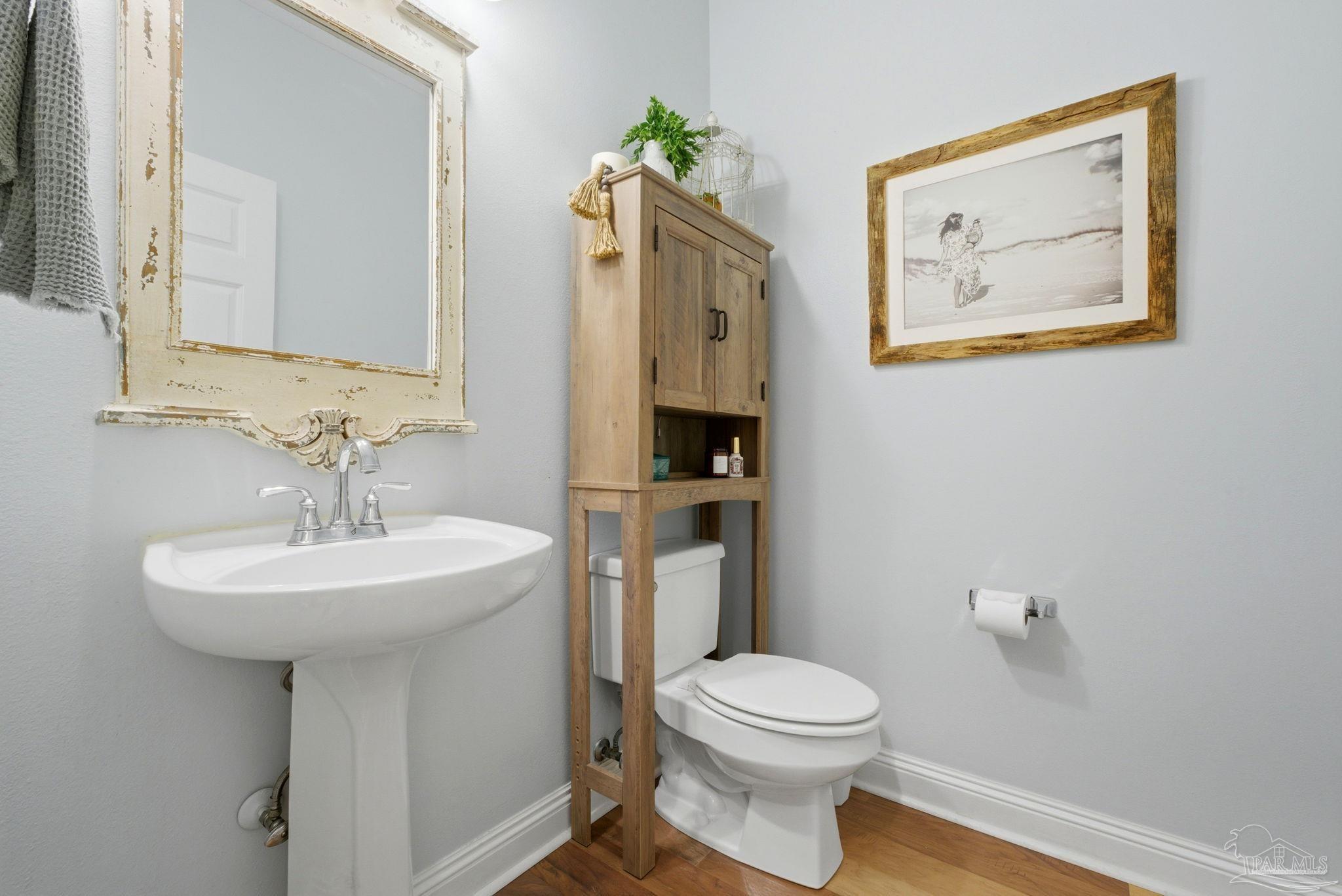5931 Otter Point Road Pensacola, FL 32504 - Photo 32 of 67 a bathroom with a toilet a sink and mirror